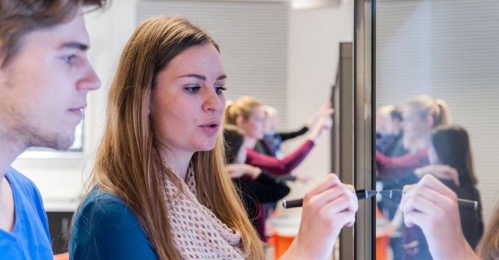 Students writing on a smartboard