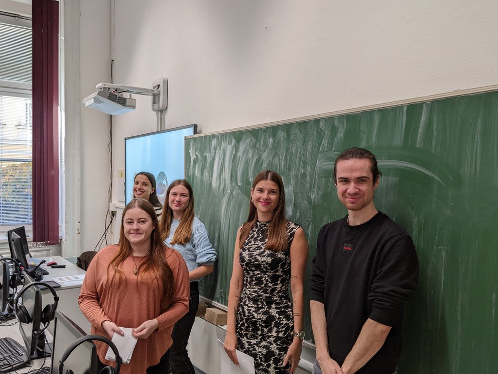 Gruppe Studierender vor Schultafel